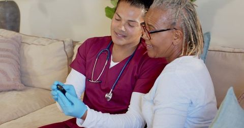 Nurse Conducting At-Home Blood Sugar Test for Senior Patient
