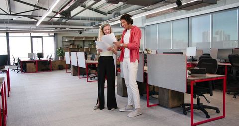 Colleagues celebrating success in modern office