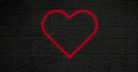 Glowing Neon Heart on Brick Wall Background