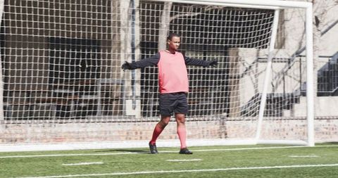 Confident Goalkeeper Standing Guard in Action-Packed Soccer Game