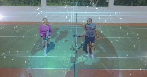 Senior Couple Playing Paddle on Court with Digital Network Concept