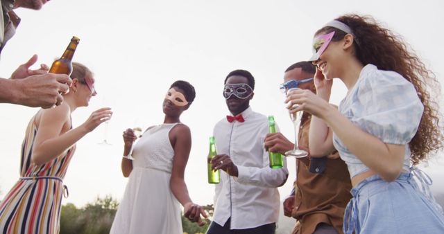 Portrait of happy african american married couple with diverse friends drinking beer. Wedding day, friendship, inclusivity and lifestyle concept.