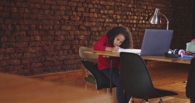 Young Girl Doing Homework on Wooden Desk with Laptop - Download Free Stock Images Pikwizard.com