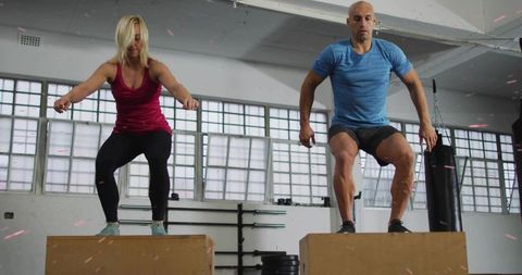 Explosive box jump workout: fitness partners performing plyometric training together