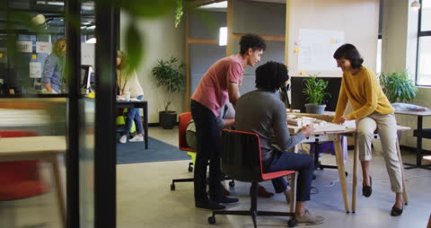 Diverse Team Engaged in Creative Office Meeting Discussion