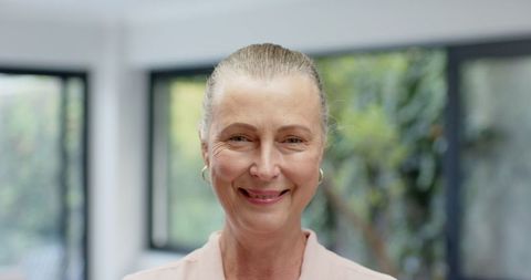 Smiling Woman in Contemporary Interior with Greenery Outside