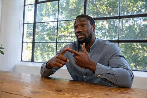 Professional Man Communicating at Meeting Table with Natural Light