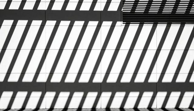 Diagonal Shadow Bands on White Tile Facade with Metal Louver for Minimalist Design