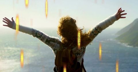 Woman with Backpack Embracing Breathtaking Coastal View