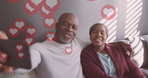 Joyful African American Senior Couple Taking Selfie with Love Symbol Overlays
