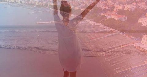 Woman raising arms over coastal sunrise silhouette with aerial seaside double exposure