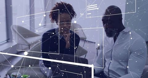 Collaborating on data analytics dashboard with digital network overlay in modern office