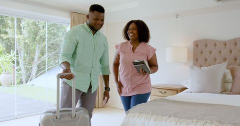 Couple Packing Suitcase in Cozy Bedroom for Romantic Getaway