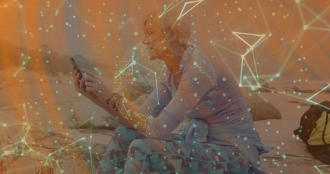 Woman Using Smartphone on Rocky Shoreline With Digital Overlay