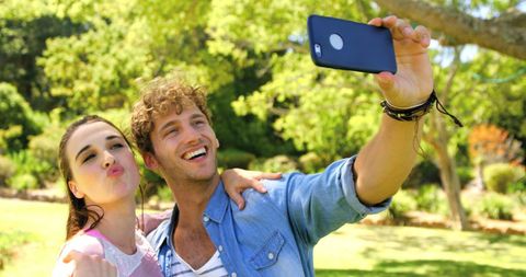 Couple Capturing Sunny Day Selfie with Perfect Smiles Outdoors - Download Free Stock Images Pikwizard.com