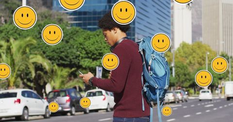 Smiling Emojis Overlaying Tech-Savvy African American Male