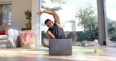 Man Doing Online Yoga Workout in Sunny Living Room