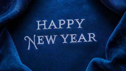 Camera Pushing In on Velvet Revealing HAPPY NEW YEAR Embroidery with Drifting Sparkles