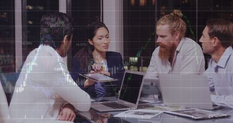 Business Team Analyzing Stock Market Data on Laptops