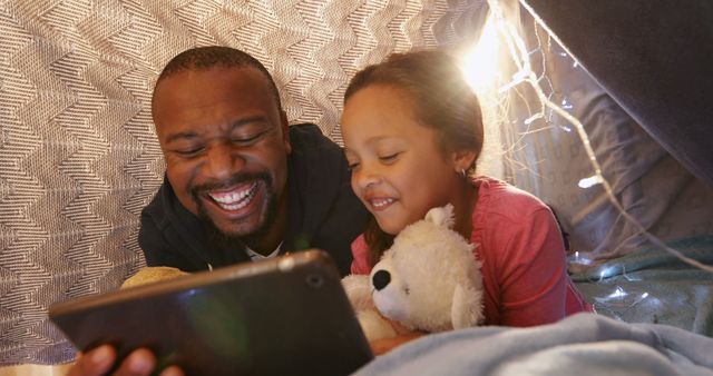 Father and Daughter Watching Tablet Inside Cozy Blanket Fort - Download Free Stock Images Pikwizard.com