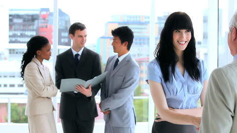 Professional Team Engaged in Lively Discussion in Modern Office