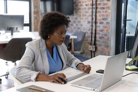 Woman Focused on Computer in Modern Office Setting