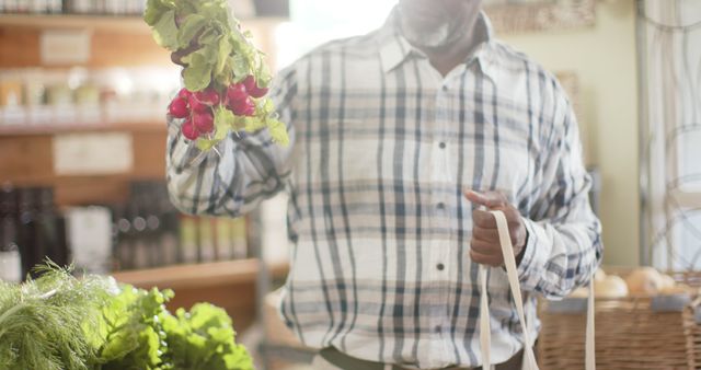 Man Shopping for Fresh Vegetables, Holding Radishes - Download Free Stock Images Pikwizard.com