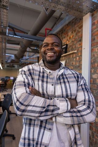 Smiling Professional in Modern Industrial Office Space