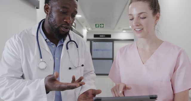 Doctor Discussing Medical Chart with Nurse in Hospital Corridor - Download Free Stock Images Pikwizard.com