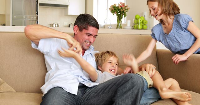 Joyful Family Couch Playtime in Modern Living Room - Download Free Stock Images Pikwizard.com