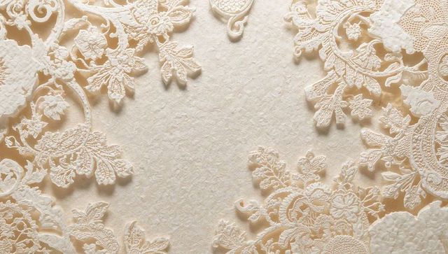 Cream laser-cut lace paper overlays crafting elegant filigree border for wedding invites