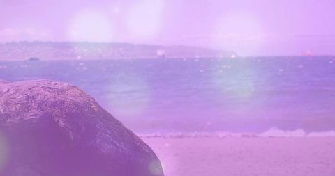 Tranquil Seascape with Sandy Shoreline and Textured Rock