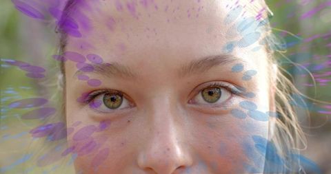Freckled woman closeup with iridescent purple-blue overlays, natural eyes outdoor portrait