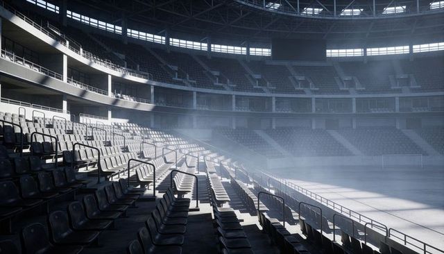 Empty modern stadium seating bathed in skylight, shadows and architectural geometry