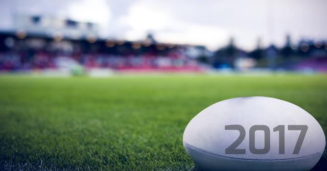 Digital composite image of rugby ball with 2017 on green grass