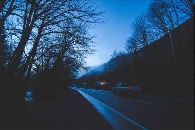 Misty Evening Country Road with Car Under Blue Twilight Sky - Download Free Stock Images Pikwizard.com