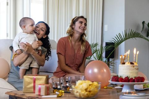Diverse Family Celebrating Birthday Together with Cake and Gifts