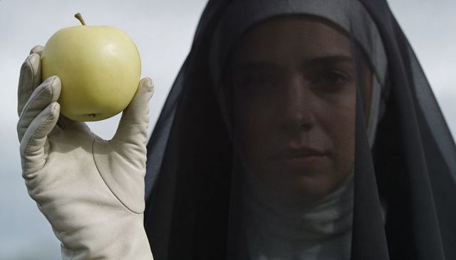 Veiled woman holding green apple with white glove moody overcast cinematic portrait