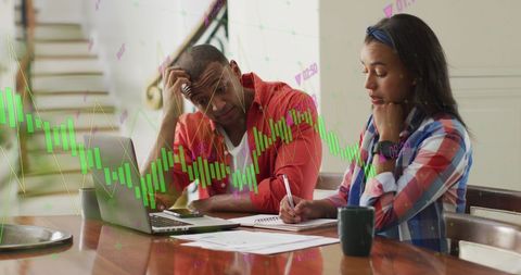 Diverse Business Team Analyzing Financial Data Charts on Laptop