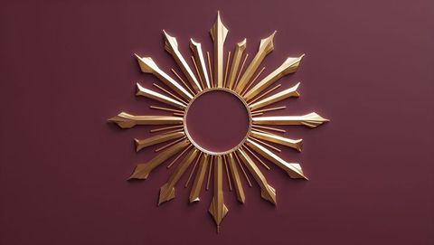 Golden sunburst decor on burgundy wall for modern elegance