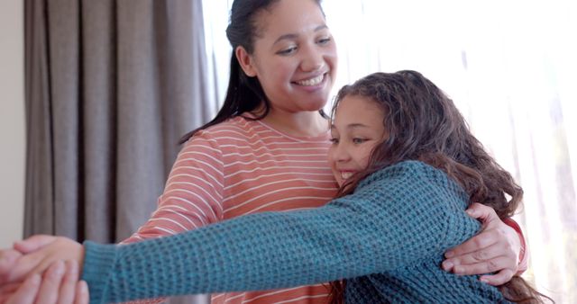 Happy Mother Hugging Young Daughter at Home in Sunlit Living Room - Download Free Stock Images Pikwizard.com