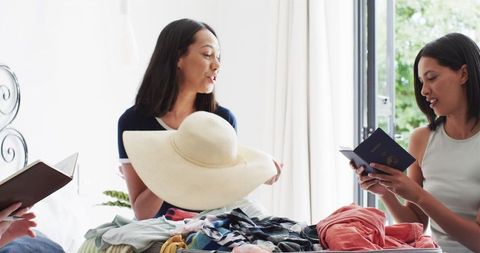 Diverse Friends Joyfully Packing for Summer Vacation
