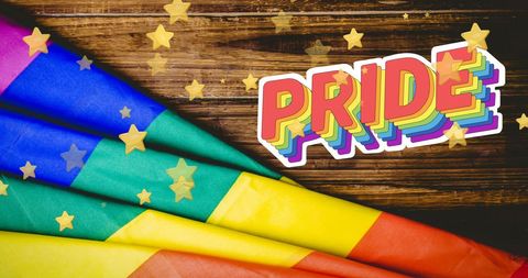 Rainbow flag with pride typography and stars celebration