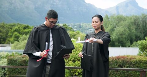Outdoor Graduation Celebration with Young Graduates Feeling Joyful