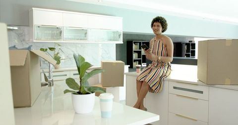 Couple relaxing in new kitchen during move