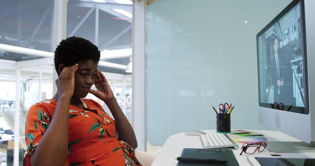 Young African American woman looks stressed in a modern office - Download Free Stock Photos Pikwizard.com