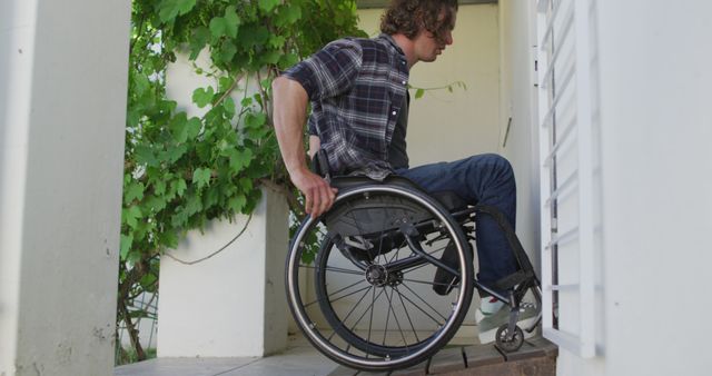 Man in Wheelchair Entering Building Through Accessibility Ramp - Download Free Stock Images Pikwizard.com