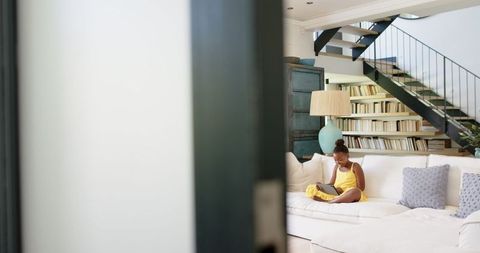 Girl Relaxing on Couch Using Tablet in Cozy Living Room - Download Free Stock Images Pikwizard.com