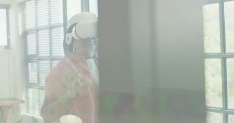 Woman wearing vr headset interacting with virtual interface through office glass and gestures