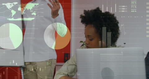 Businesswoman Analyzing Data on Laptop with Digital Graph Overlays